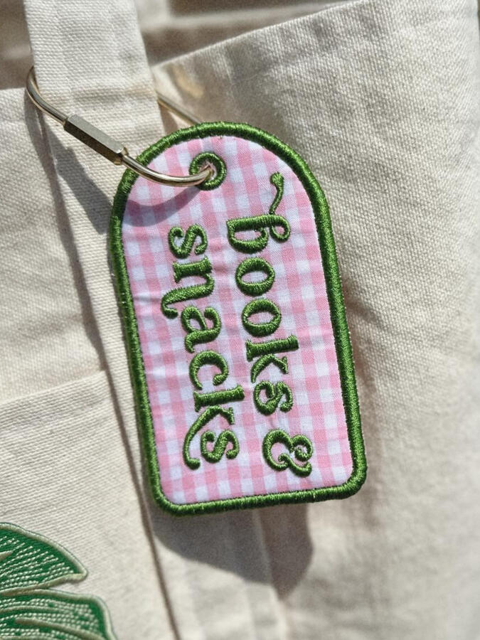 Machine embroidered book tags, perfect for adding a little personality to your bag. Customize with your choice of thread and fabric colors. Finished with a gold carabiner for easy attachment. $15