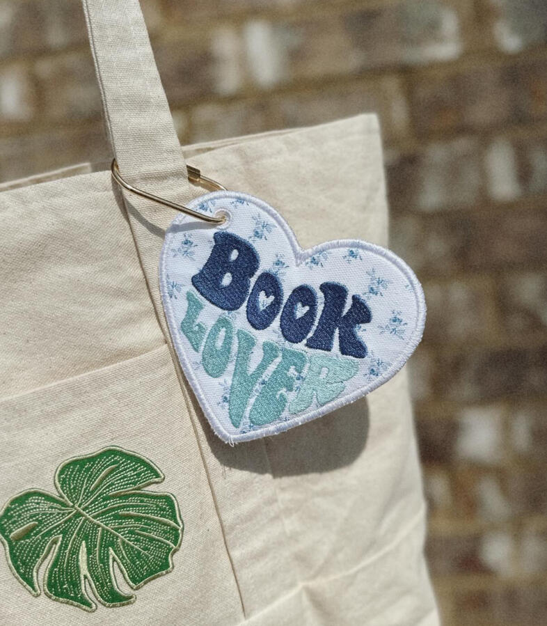 Machine embroidered book tags, perfect for adding a little personality to your bag. Customize with your choice of thread and fabric colors. Finished with a gold carabiner for easy attachment. $15